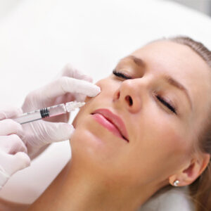 Botox Facial Injection Procedure Woman receiving Botox injection in cheek area