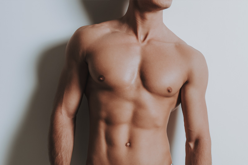 Young shirtless athletic man standing in black underwear