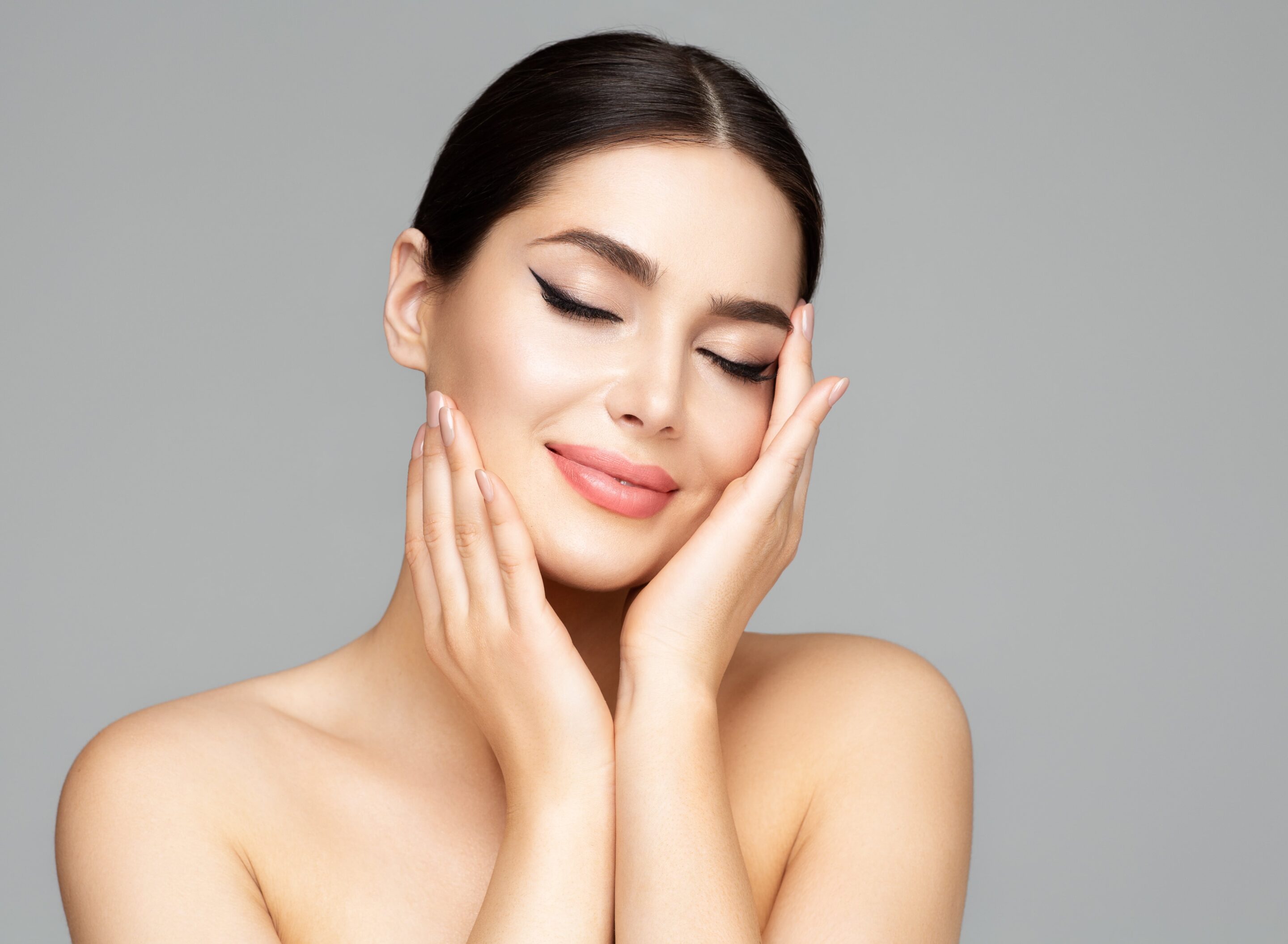 Woman face skin care beauty model holding face in hands Woman face skin care beauty model holding face in hands